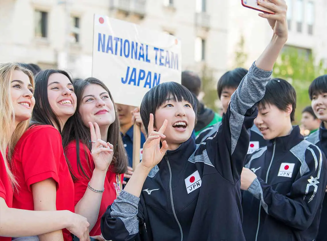 happy Japanese volleyball player taking a selfie in Italy
